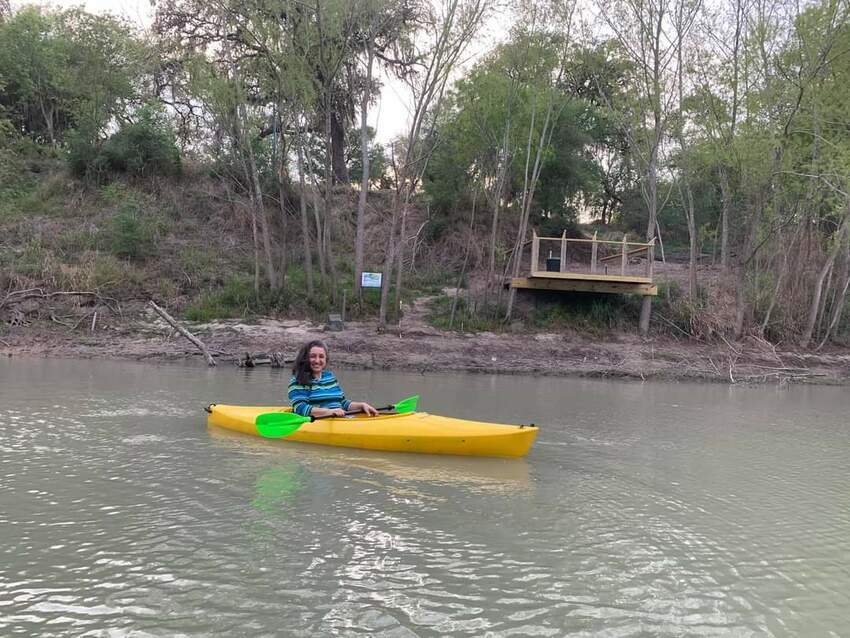 Becky Kayaking In From Of Fishing Pier